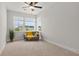 Spacious bedroom with neutral walls, carpet, a ceiling fan, and a comfy grey loveseat at 361 Ripple Park Dr, Summerville, SC 29486