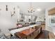 Open-concept dining room with a dark wood table, bench seating, and views into the kitchen and living spaces at 361 Ripple Park Dr, Summerville, SC 29486