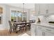 Bright dining room with a dark wood table, modern chandelier and sliding glass doors to the backyard at 361 Ripple Park Dr, Summerville, SC 29486