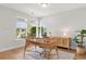 Bright home office features wood floors, a unique rattan desk and chair, and large windows at 361 Ripple Park Dr, Summerville, SC 29486