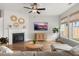 Comfortable living room featuring a fireplace, ceiling fan, and abundant natural light at 361 Ripple Park Dr, Summerville, SC 29486