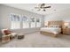 Serene main bedroom with large windows, neutral tones, and a cozy seating area at 361 Ripple Park Dr, Summerville, SC 29486