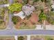 Aerial view of coastal home with stone driveway, mature landscaping, wooden walkway, and rooftop deck at 3635 Pompano Ct, Seabrook Island, SC 29455