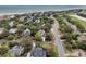 Aerial view of a coastal home surrounded by lush landscaping, with nearby beach access at 3635 Pompano Ct, Seabrook Island, SC 29455