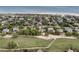 This aerial shows homes nestled amongst mature trees near the ocean and a well manicured golf course at 3635 Pompano Ct, Seabrook Island, SC 29455
