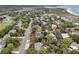 Aerial view of a coastal neighborhood with a long road, lush landscaping, and nearby beach at 3635 Pompano Ct, Seabrook Island, SC 29455