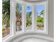 Bright bay window view featuring lush palm trees and tropical greenery, bringing the outdoors in at 3635 Pompano Ct, Seabrook Island, SC 29455