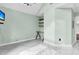 Spacious bedroom featuring sleek marble floors and built-in shelving for ample storage at 3635 Pompano Ct, Seabrook Island, SC 29455