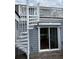 Exterior view featuring a unique spiral staircase leading to the upper deck and sliding glass doors for easy access at 3635 Pompano Ct, Seabrook Island, SC 29455