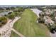 Aerial view of a lush golf course and a tranquil pond surrounded by mature trees and beautiful homes at 3635 Pompano Ct, Seabrook Island, SC 29455