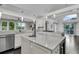 Spacious kitchen with stainless steel appliances, white cabinets and a large marble island counter at 3635 Pompano Ct, Seabrook Island, SC 29455