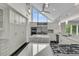 Bright modern kitchen with large windows, stainless steel appliances, island sink and marble countertops at 3635 Pompano Ct, Seabrook Island, SC 29455