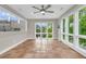 Bright living room featuring terra cotta tile flooring and an abundance of natural light from large windows at 3635 Pompano Ct, Seabrook Island, SC 29455