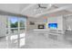 Contemporary living room with a fireplace, custom built-ins, and expansive windows at 3635 Pompano Ct, Seabrook Island, SC 29455