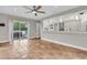 Spacious living room with deck access, featuring terra cotta tile flooring and a pass-through to the kitchen at 3635 Pompano Ct, Seabrook Island, SC 29455
