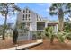 Rear view of this two-story home with multiple decks and lush landscaping at 3635 Pompano Ct, Seabrook Island, SC 29455
