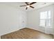 An empty bedroom with wood floors, ceiling fan, and a window with curtains at 3802 Annapolis Way, Ladson, SC 29456