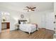 Bright bedroom features a ceiling fan and wood-look flooring, and ensuite bathroom at 3802 Annapolis Way, Ladson, SC 29456
