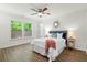 Serene bedroom with wood floors, ceiling fan, and large windows providing natural light at 3802 Annapolis Way, Ladson, SC 29456