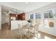 Cozy dining area with white table, tile floors, and adjacent kitchen at 3802 Annapolis Way, Ladson, SC 29456