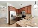 Modern kitchen with granite countertops, stainless steel appliances, and wooden cabinets at 3802 Annapolis Way, Ladson, SC 29456