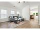 Spacious living room showcasing wood floors, a gray sectional, and plenty of natural light at 3802 Annapolis Way, Ladson, SC 29456