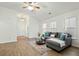 Bright living room featuring wood flooring, neutral walls, and a comfortable gray sectional at 3802 Annapolis Way, Ladson, SC 29456