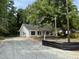 New construction white home with black shutters, situated on a lot filled with mature trees at 419 Ravenwood Rd, Walterboro, SC 29488