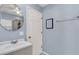 Clean bathroom with a white vanity, large mirror, white door, and a towel rack at 4807 Habersham Ln, Summerville, SC 29485