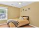 Bright bedroom with yellow walls and a large bed with a grey patterned blanket at 4807 Habersham Ln, Summerville, SC 29485