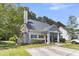 Charming home featuring a well-manicured lawn, mature landscaping, and a welcoming front porch at 4807 Habersham Ln, Summerville, SC 29485