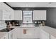 Efficient white kitchen equipped with modern appliances, ample counter space, and convenient storage options at 4807 Habersham Ln, Summerville, SC 29485