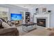 Inviting living room with a cozy fireplace, TV, and comfortable seating, perfect for entertaining at 4807 Habersham Ln, Summerville, SC 29485