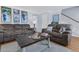 Spacious living room with comfortable seating, a coffee table, and an open layout with staircase access at 4807 Habersham Ln, Summerville, SC 29485