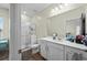 Well-lit bathroom featuring white cabinets, granite countertops, shower, and a view into the bedroom at 483 Pender Woods Dr, Summerville, SC 29486