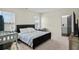 Cozy bedroom features neutral walls, carpet floors, a dark bed frame and a view into the bathroom at 483 Pender Woods Dr, Summerville, SC 29486