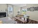 Bright dining area features wood floors, fireplace, sliding glass doors, and wooden table with bench seating at 483 Pender Woods Dr, Summerville, SC 29486