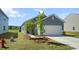 Charming home with blue siding, a two-car garage, and professionally landscaped front yard at 483 Pender Woods Dr, Summerville, SC 29486