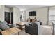 Comfortable living area featuring neutral tones, a large TV, and an inviting sofa at 483 Pender Woods Dr, Summerville, SC 29486
