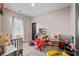 Bright room featuring a bed, doll house, play kitchen, and carpet floors at 483 Pender Woods Dr, Summerville, SC 29486