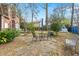 Backyard with a table, swing set, and mature trees, perfect for relaxing and playing at 49 Crosscreek Dr, Charleston, SC 29412