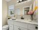 Charming bathroom with marble countertop vanity, white cabinets, and decorative accents at 49 Crosscreek Dr, Charleston, SC 29412