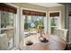 Dining area featuring large bay windows and a view of the landscaped backyard at 49 Crosscreek Dr, Charleston, SC 29412