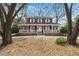 Charming two-story home with a classic wrap-around porch, situated on a lot with mature trees offering natural beauty at 49 Crosscreek Dr, Charleston, SC 29412