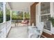 Charming porch with a swing, classic white railings, and cozy seating, creating a welcoming outdoor space at 49 Crosscreek Dr, Charleston, SC 29412