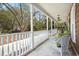 Spacious front porch offering ample seating, perfect for outdoor enjoyment and relaxation with classic white railings at 49 Crosscreek Dr, Charleston, SC 29412