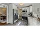 Bright kitchen features stainless steel appliances, white cabinets and access to dining room and backyard at 49 Crosscreek Dr, Charleston, SC 29412