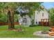 Spacious backyard featuring a swing, firepit, privacy fence, and mature trees at 5418 Percival Ln, Charleston, SC 29420