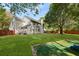 Expansive backyard with lush green lawn, play area, mature trees, and a privacy fence at 5418 Percival Ln, Charleston, SC 29420