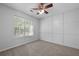 Neutral bedroom with carpet flooring, ceiling fan, and a window providing natural light at 5418 Percival Ln, Charleston, SC 29420